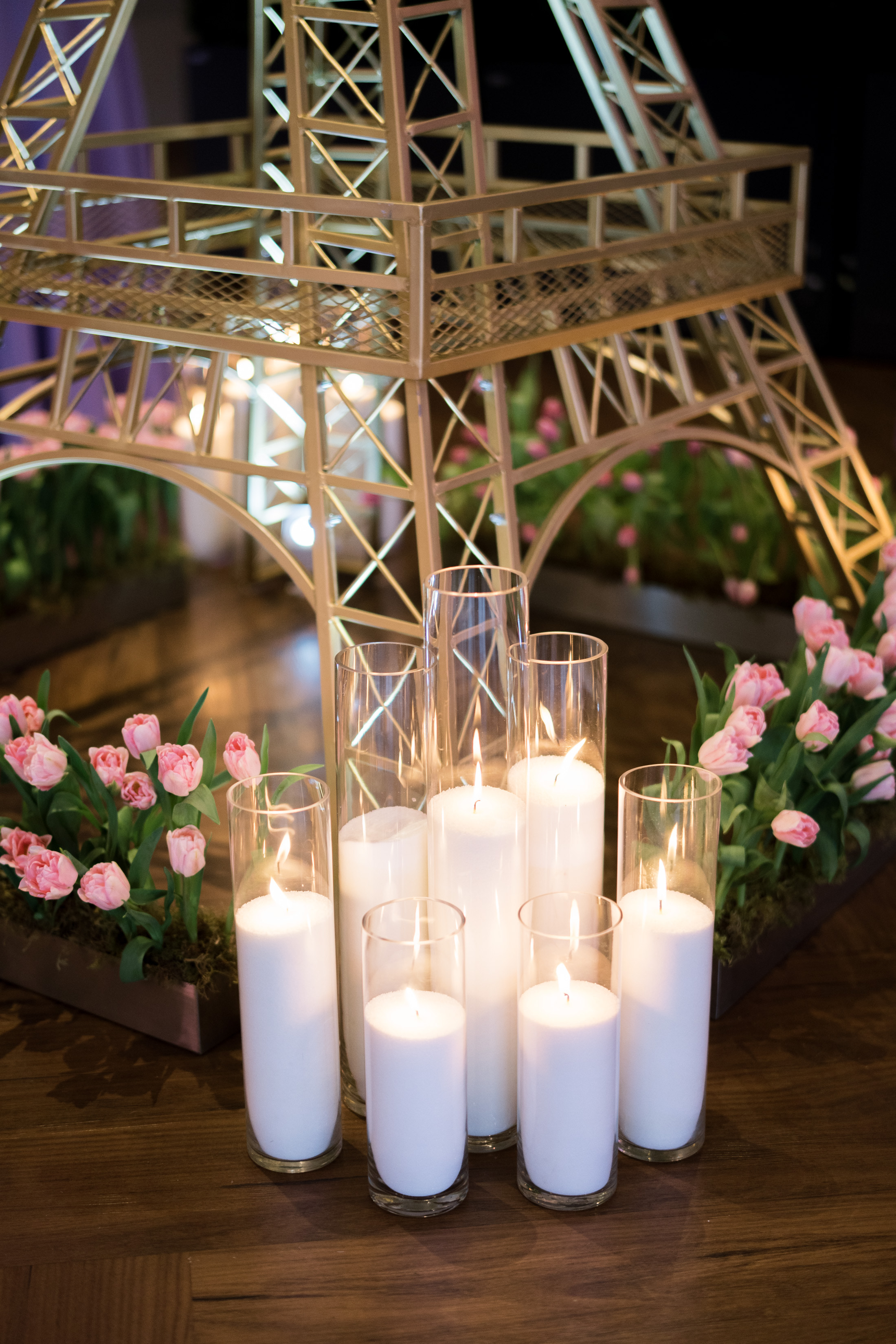 A custom built eiffle tower and hundreds of Hurricane Wax Candles